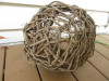 Basket lying on its side on a porch, showing bottom